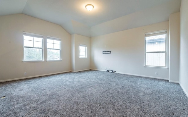 unfurnished room featuring baseboards, carpet flooring, and vaulted ceiling