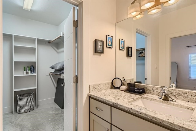 2012 Willow St Unit B, Austin, TX 78702 - bathroom featuring vanity, a spacious closet, and baseboards