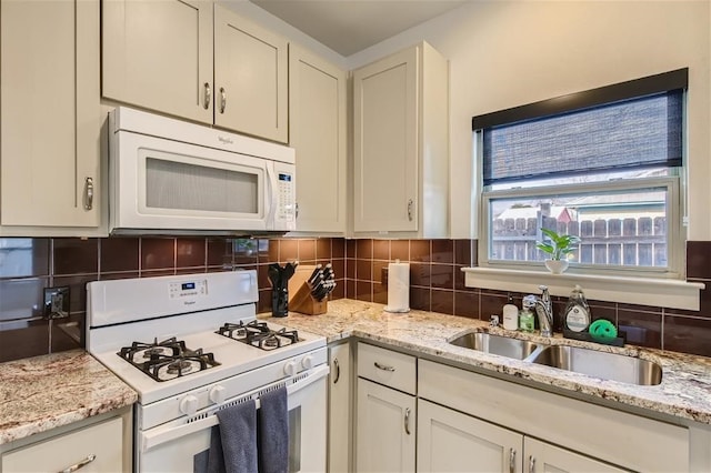2012 Willow St Unit B, Austin, TX 78702 - kitchen featuring white appliances, a sink, decorative backsplash, and light stone counters