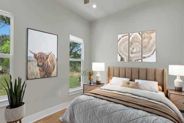 414 Wesley Ridge Dr, Spicewood, TX 78669 - bedroom with wood finished floors, multiple windows, and recessed lighting