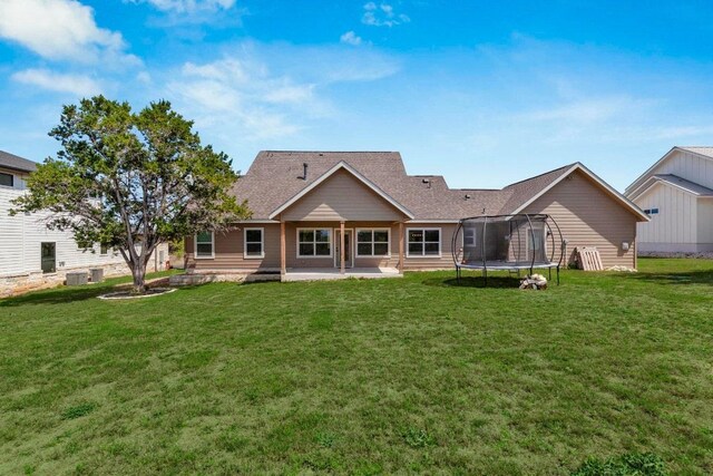 414 Wesley Ridge Dr, Spicewood, TX 78669 - rear view of house with a patio area, a trampoline, and a yard