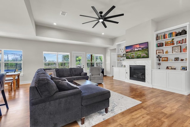 414 Wesley Ridge Dr, Spicewood, TX 78669 - living area featuring ceiling fan, light wood finished floors, recessed lighting, a premium fireplace, and built in shelves