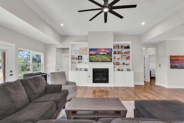 414 Wesley Ridge Dr, Spicewood, TX 78669 - living area featuring radiator, ceiling fan, light wood-style flooring, a fireplace, and recessed lighting