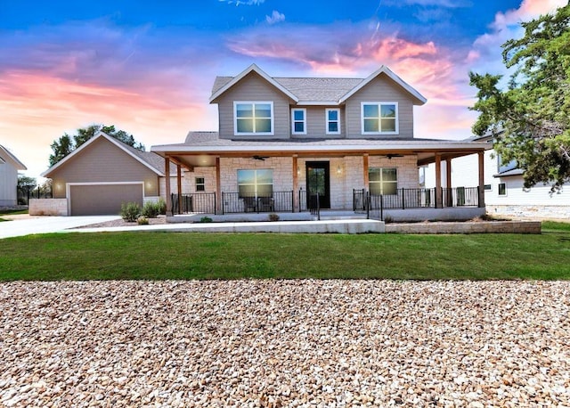 414 Wesley Ridge Dr, Spicewood, TX 78669 - view of front facade with a porch, a lawn, stone siding, concrete driveway, and a garage