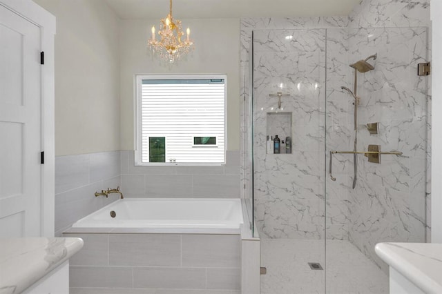 414 Wesley Ridge Dr, Spicewood, TX 78669 - bathroom featuring a marble finish shower, an inviting chandelier, and a garden tub