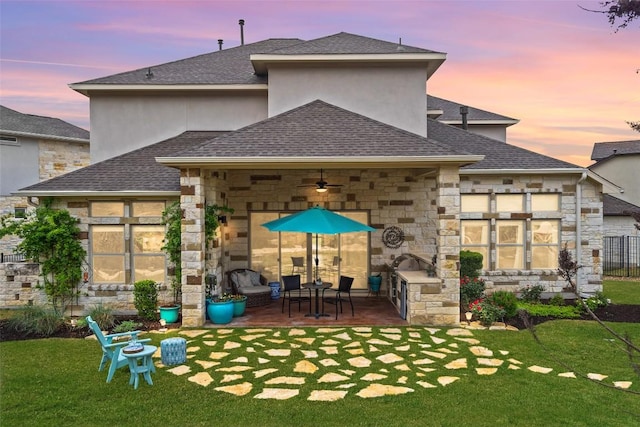 308 Highland Village Cv, Austin, TX 78738 - back of property with a ceiling fan, a shingled roof, and stone siding