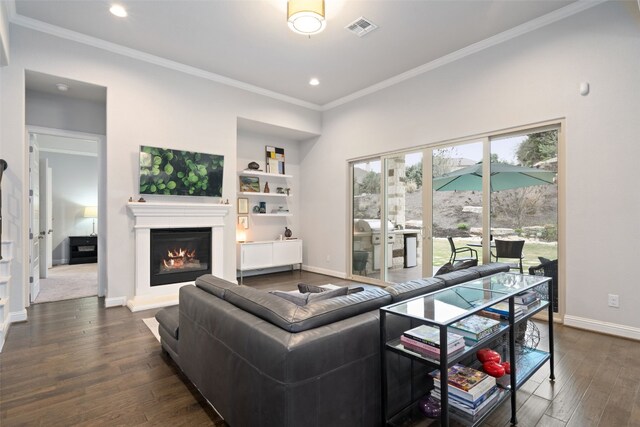308 Highland Village Cv, Austin, TX 78738 - living area with crown molding, baseboards, dark wood-style floors, recessed lighting, and a lit fireplace
