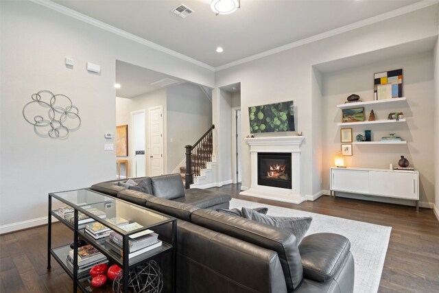 308 Highland Village Cv, Austin, TX 78738 - living room featuring ornamental molding, stairway, baseboards, dark wood-type flooring, and a glass covered fireplace