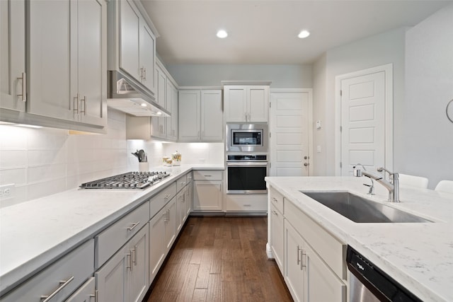 308 Highland Village Cv, Austin, TX 78738 - kitchen featuring appliances with stainless steel finishes, a sink, tasteful backsplash, under cabinet range hood, and recessed lighting