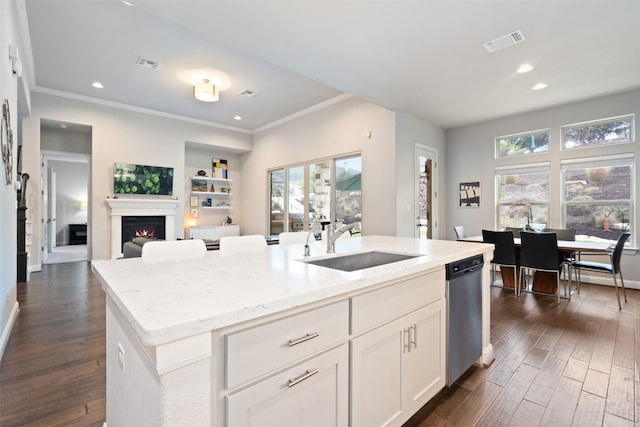 308 Highland Village Cv, Austin, TX 78738 - kitchen featuring a sink, stainless steel dishwasher, dark wood finished floors, open floor plan, and light stone countertops