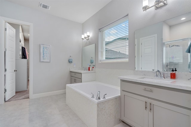 308 Highland Village Cv, Austin, TX 78738 - bathroom with a shower stall, two vanities, a bath, tile patterned flooring, and a closet