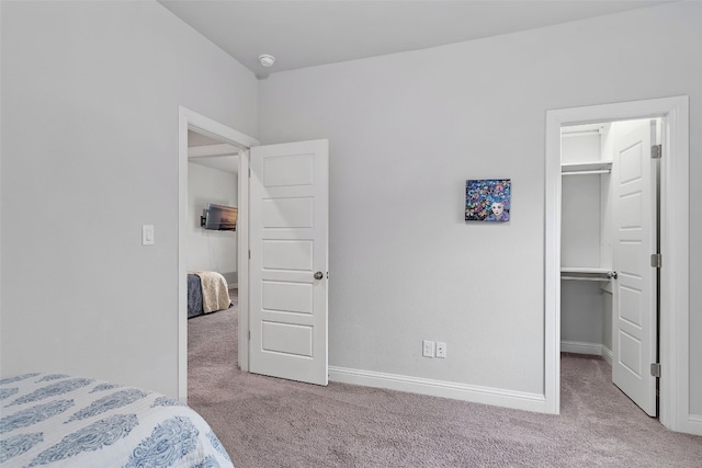 308 Highland Village Cv, Austin, TX 78738 - carpeted bedroom with a walk in closet, baseboards, and a closet