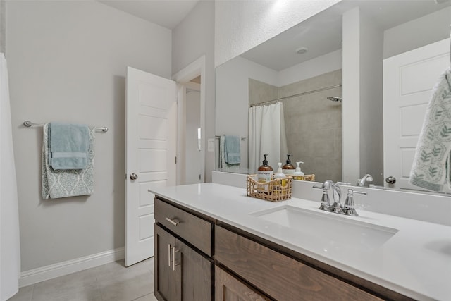 308 Highland Village Cv, Austin, TX 78738 - full bathroom featuring vanity, tile patterned flooring, tiled shower, and baseboards