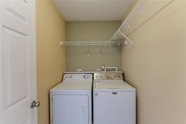 washroom featuring independent washer and dryer and laundry area