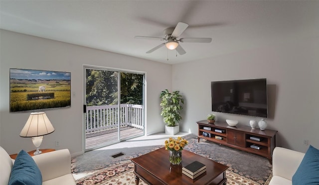 carpeted living room with visible vents and a ceiling fan