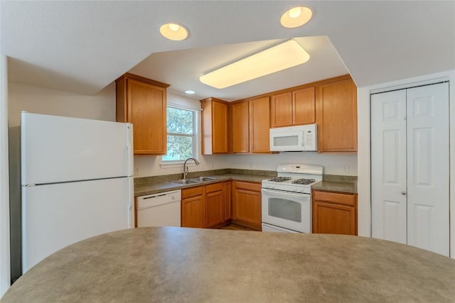 kitchen featuring white appliances, recessed lighting, brown cabinets, and a sink