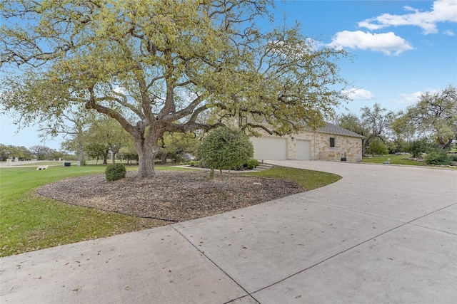 334 Sapling Dr, Driftwood, TX 78619 - view of front facade with a garage, driveway, a front lawn, and stone siding