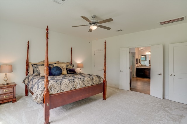 334 Sapling Dr, Driftwood, TX 78619 - bedroom with light carpet, ceiling fan, and ensuite bathroom
