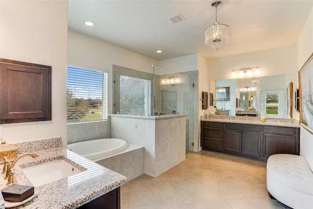 334 Sapling Dr, Driftwood, TX 78619 - full bath featuring a shower stall, two vanities, tile patterned floors, a bath, and a chandelier