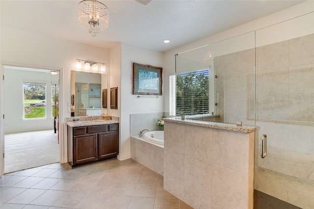 334 Sapling Dr, Driftwood, TX 78619 - bathroom with a garden tub, a shower stall, tile patterned flooring, vanity, and a chandelier