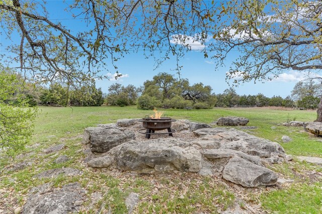 334 Sapling Dr, Driftwood, TX 78619 - view of grassy yard with a fire pit