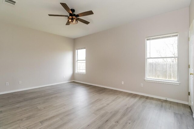 11817 Bastrop St, Manor, TX 78653 - empty room featuring a ceiling fan and light wood-style floors
