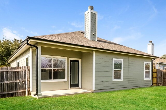11817 Bastrop St, Manor, TX 78653 - rear view of property with a chimney and a shingled roof