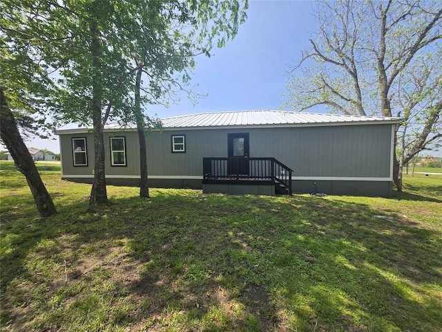 507 W 1st St, Flatonia, TX 78941 - back of house with a yard, a metal roof, and a deck