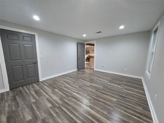507 W 1st St, Flatonia, TX 78941 - empty room featuring dark wood finished floors and recessed lighting