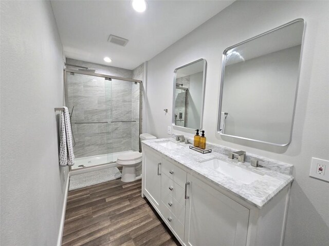507 W 1st St, Flatonia, TX 78941 - bathroom with double vanity, a stall shower, wood finished floors, and recessed lighting