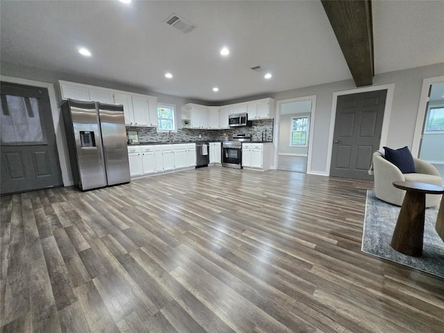 507 W 1st St, Flatonia, TX 78941 - kitchen with appliances with stainless steel finishes, tasteful backsplash, wood finished floors, white cabinetry, and recessed lighting