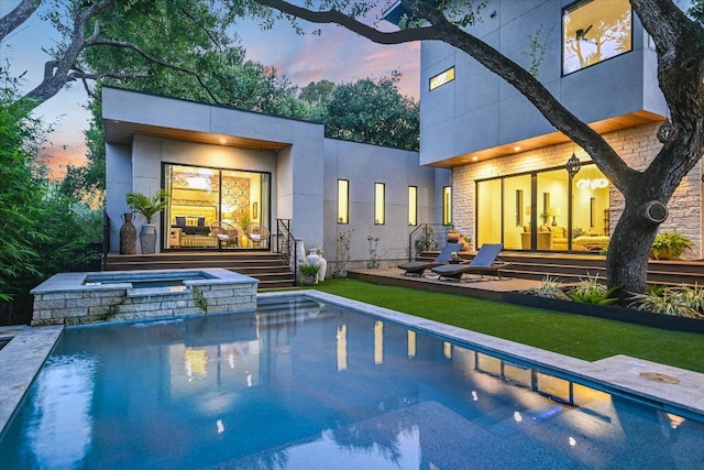 403 Ridgewood, Austin, TX 78746 - rear view of property featuring a pool with connected hot tub and stucco siding