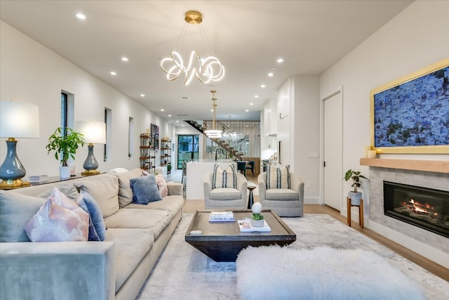 403 Ridgewood, Austin, TX 78746 - living room with a glass covered fireplace, a chandelier, recessed lighting, and wood finished floors