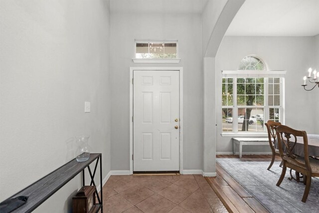 2319 Rock Ledge Dr, Georgetown, TX 78626 - tiled entryway featuring arched walkways, plenty of natural light, and a chandelier