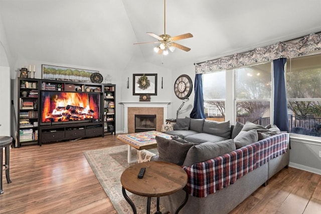 2319 Rock Ledge Dr, Georgetown, TX 78626 - living room featuring a tiled fireplace, ceiling fan, vaulted ceiling, and wood finished floors