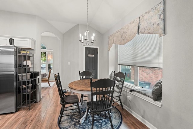 2319 Rock Ledge Dr, Georgetown, TX 78626 - dining space featuring wood finished floors, arched walkways, a chandelier, and vaulted ceiling