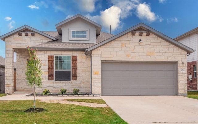 8021 Arezzo Dr, Round Rock, TX 78665 - view of front of home featuring roof with shingles, an attached garage, driveway, stone siding, and a front lawn