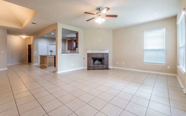 8021 Arezzo Dr, Round Rock, TX 78665 - unfurnished living room with a ceiling fan, a tiled fireplace, baseboards, light tile patterned floors, and recessed lighting