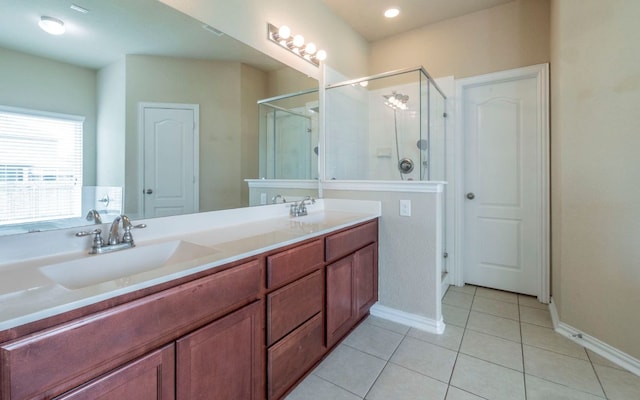 8021 Arezzo Dr, Round Rock, TX 78665 - bathroom featuring tile patterned flooring, a shower stall, double vanity, and baseboards