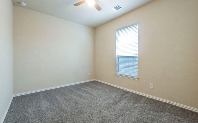 8021 Arezzo Dr, Round Rock, TX 78665 - spare room featuring dark colored carpet, ceiling fan, baseboards, and a smoke detector