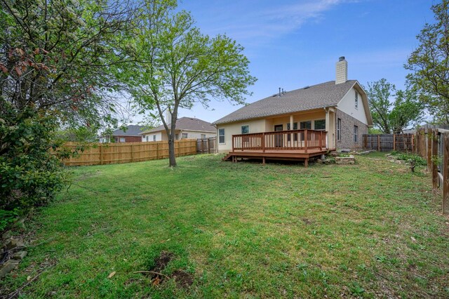 720 Northcreek Blvd, Leander, TX 78641 - rear view of property with a fenced backyard, a deck, a chimney, and brick siding