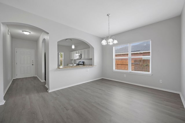 720 Northcreek Blvd, Leander, TX 78641 - unfurnished living room with dark wood finished floors and a chandelier