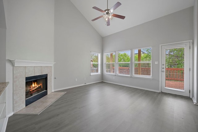 720 Northcreek Blvd, Leander, TX 78641 - unfurnished living room with high vaulted ceiling, dark wood-style flooring, ceiling fan, and a tile fireplace