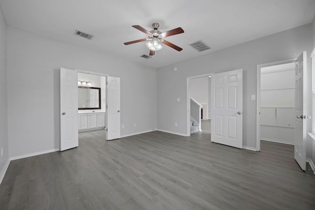 720 Northcreek Blvd, Leander, TX 78641 - unfurnished bedroom with dark wood-style floors, a walk in closet, ensuite bath, and ceiling fan