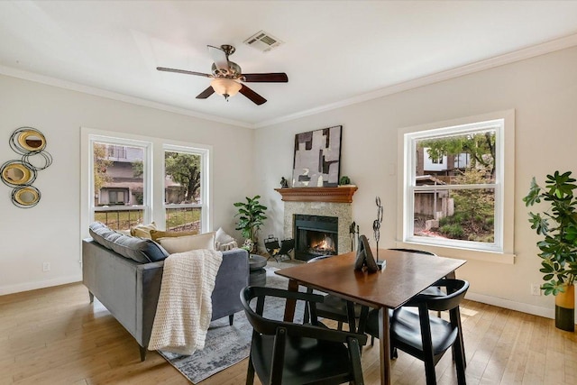 802 S 1st St Unit 225, Austin, TX 78704 - living area with a warm lit fireplace, ceiling fan, light wood-type flooring, and crown molding