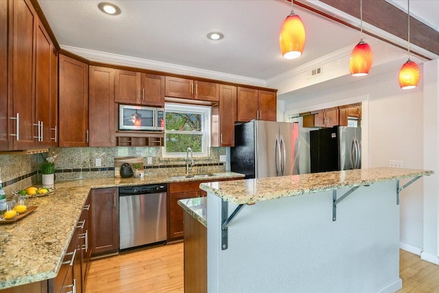 802 S 1st St Unit 225, Austin, TX 78704 - kitchen with appliances with stainless steel finishes, backsplash, a breakfast bar area, ornamental molding, and light wood finished floors