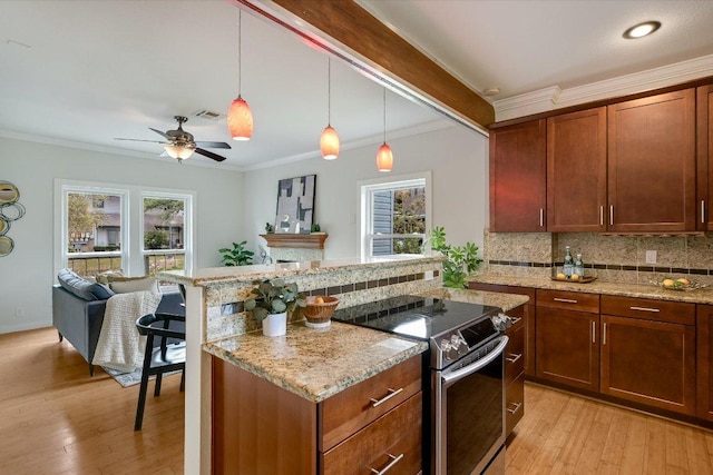 802 S 1st St Unit 225, Austin, TX 78704 - kitchen featuring stainless steel electric stove, healthy amount of natural light, tasteful backsplash, light wood finished floors, and crown molding