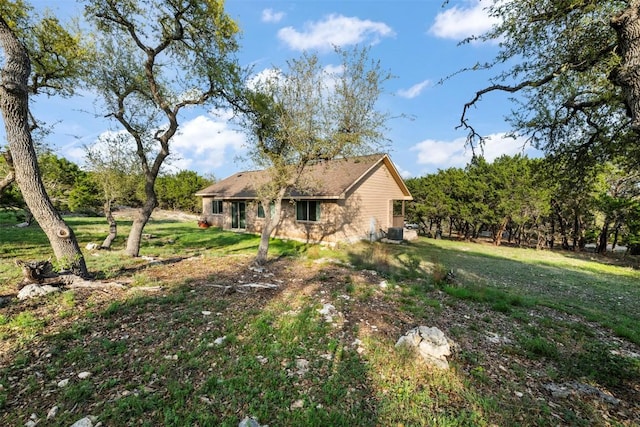 1135 Twisted Oak Ct, Canyon Lake, TX 78133 - view of home's exterior featuring a central air condition unit and a yard