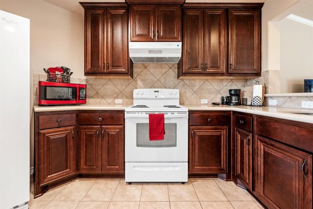 1135 Twisted Oak Ct, Canyon Lake, TX 78133 - kitchen featuring white appliances, under cabinet range hood, light countertops, and backsplash