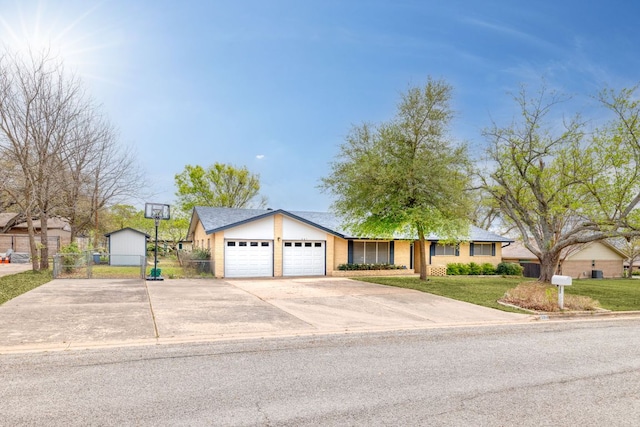 307 S 7th St, Pflugerville, TX 78660 - ranch-style home featuring an attached garage, fence, concrete driveway, and a front yard